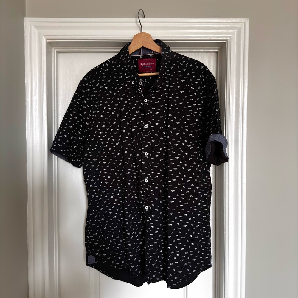 Black short sleeve shirt with paper plane motif